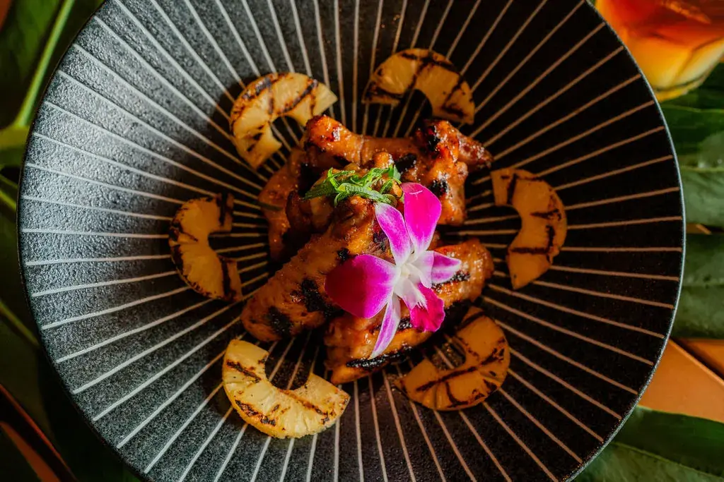 Huli Huli Chicken Wings at Voyagers in Kailua-Kona: flame-kissed wings and drumsticks over caramelized grilled pineapple