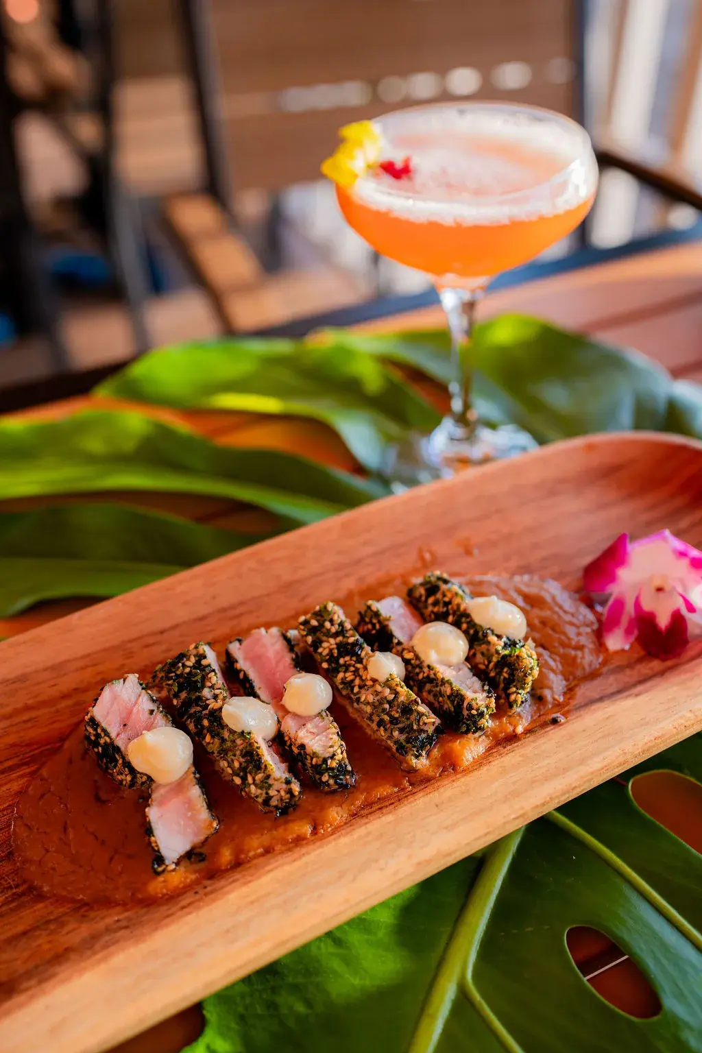 Seared Ahi at Voyagers: furikake-crusted tuna, sliced rare, with truffle aioli and ponzu butter sauce on a wooden board